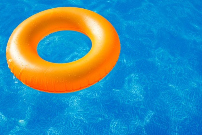 Swim ring in blue pool Swim ring in blue pool